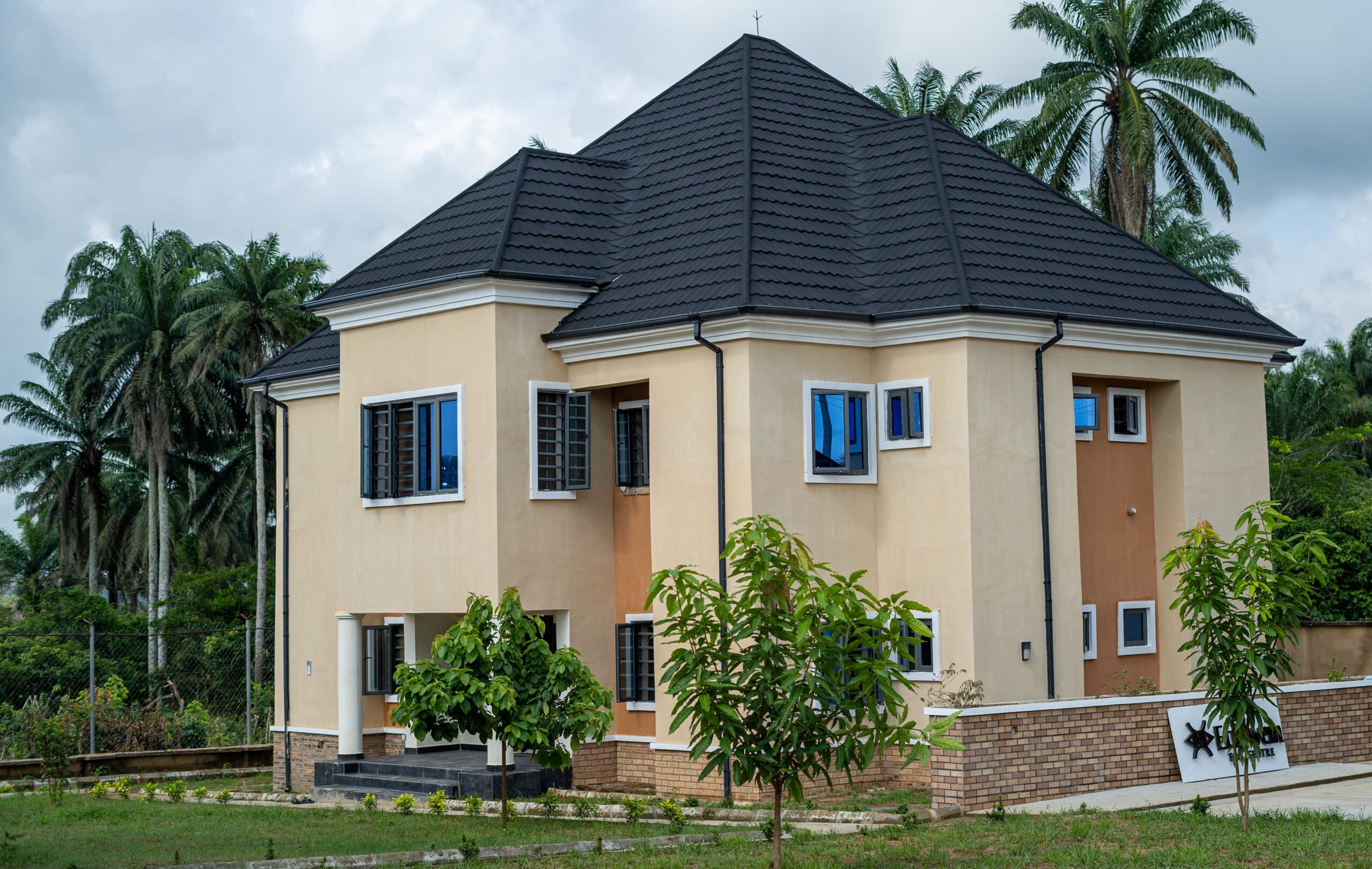 The guest house with young trees in front